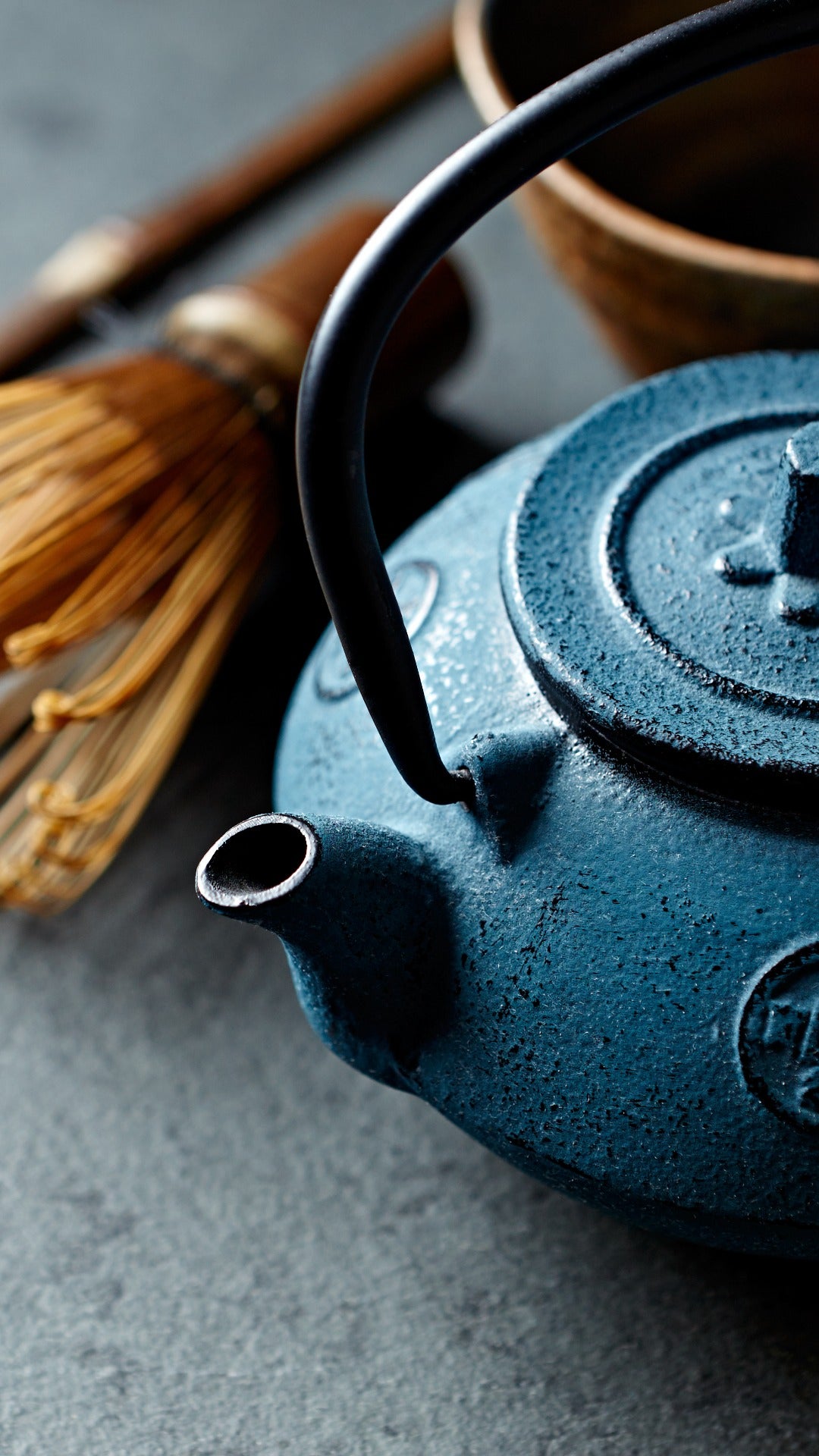 Matcha, tea utensils, tea ceremony, cast iron kettle, water kettle, pottery tea bowl, bamboo scoop and whisk, chashaku, chasen, grey background