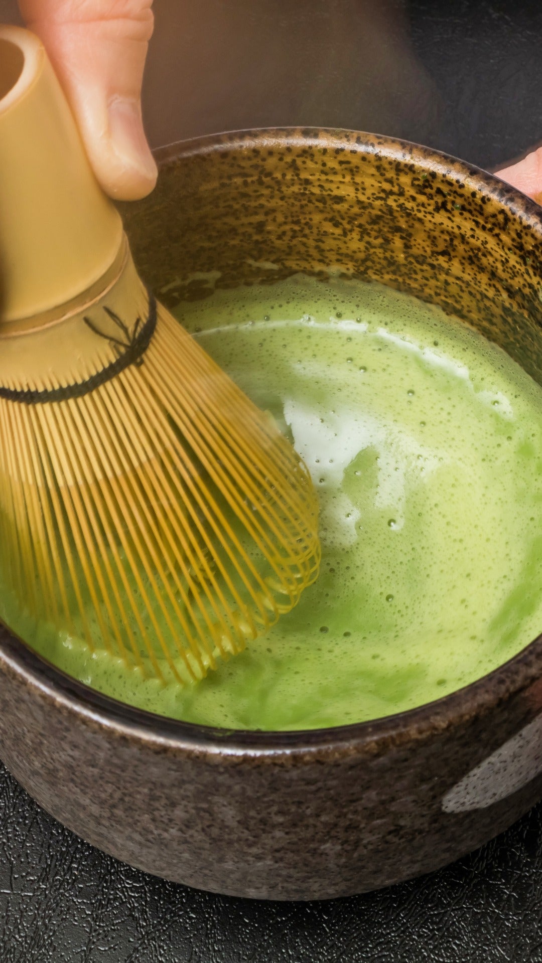 Matcha, green tea powder, bamboo matcha whisk, chasen, pottery tea bowl, chawan,hand, whisking, holding