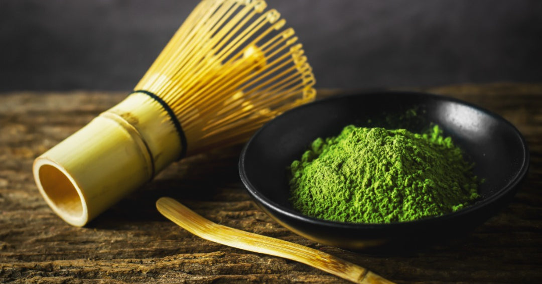 Matcha, green tea powder, bamboo scoop and whisk, chashaku, chasen, wooden table, dark grey background