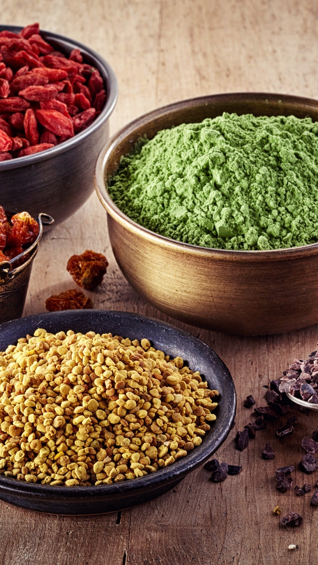 Matcha, green tea powder, superfoods, bowls, goji berries, bee pollen, dark chocolate, wooden table